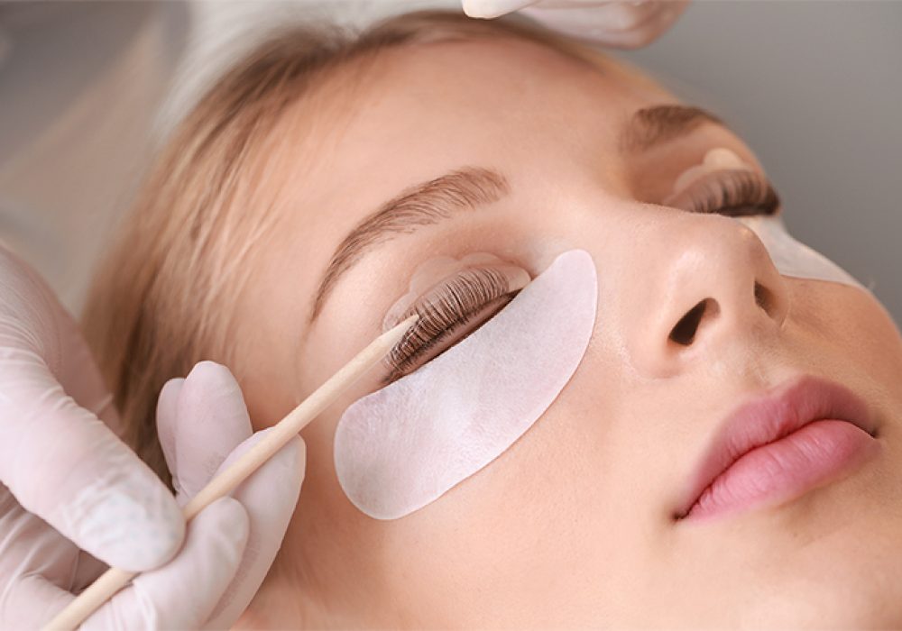 Young woman undergoing procedure of eyelashes lamination in beau Young woman undergoing procedure of eyelashes lamination in beauty salon, closeup